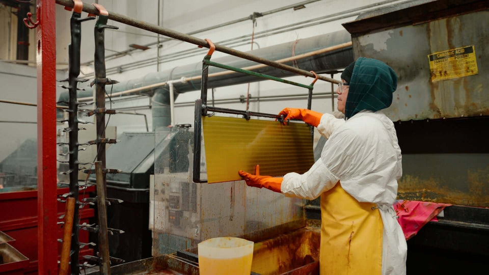 ISO Certified Manufacturer PEC Tools employee working in the manufacturing process, handling equipment and safety gear.