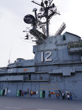 USS Hornet Museum exterior showing the iconic flight deck and crew activities on display.