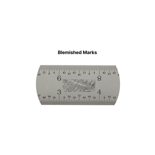 Blemished ruler showing visible surface marks and accurate measurement scale.