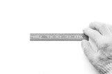Rigid Satin Chrome-Plated Steel Rulers being held by a gloved hand on a white background.