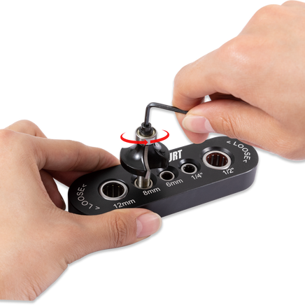 Person using a router bit vise to secure a router bit in a drill guide block for precise woodworking.